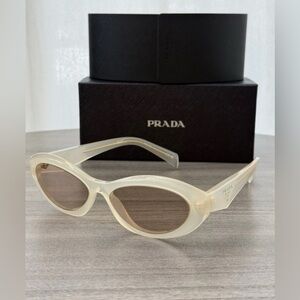 Prada PR 26ZS 12V4I2 Opal Milk Plastic Oval Sunglasses Brown Lens